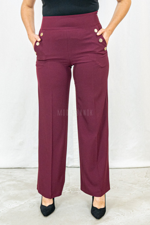 Bordowe eleganckie spodnie damskie z szeroką nogawką i rzędowymi guzikami CORALLINE- MODA SANOK Bordowe eleganckie spodnie damskie z szeroką nogawką i rzędowymi guzikami CORALLINE- MODA SANOK