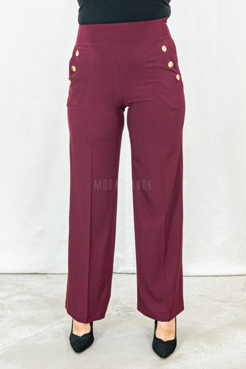 Bordowe eleganckie spodnie damskie z szeroką nogawką i rzędowymi guzikami CORALLINE- MODA SANOK Bordowe eleganckie spodnie damskie z szeroką nogawką i rzędowymi guzikami CORALLINE- MODA SANOK